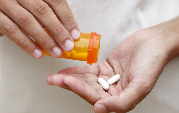 prescription medications in woman's hand