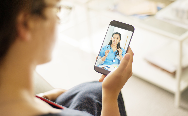 Doctor talking to a patient on a mobile phone during telemedicine video call