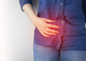 woman with Crohn's disease holding side in pain